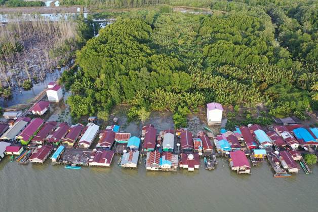 aerial view of homes along the water with shrimp farming faciltiies